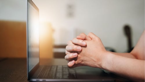 Thanksgiving picture of hands playing next to laptop computer