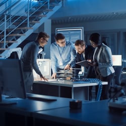 Team gathered around conference table discussing cyber strategy
