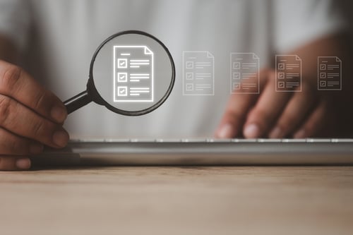 keyboard with magnifying glass showing assessment results graphic