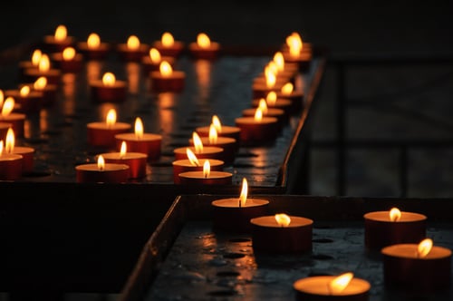 Lit candles inside dimly lit church