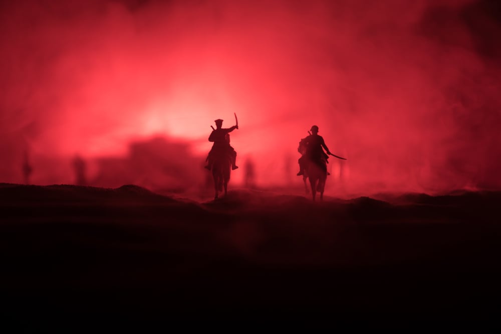 Horsemen attacking on red horizon