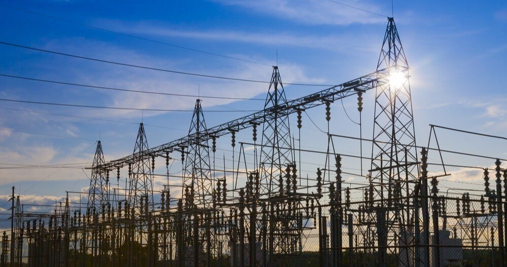 Sunset behind electical substation towers