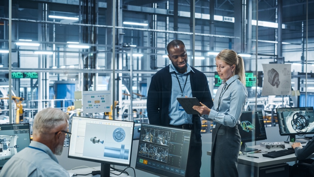 Female Engineer Talks with Male Scientist, Use Tablet Computer to Design Production Conveyor for Advanced Power Engines