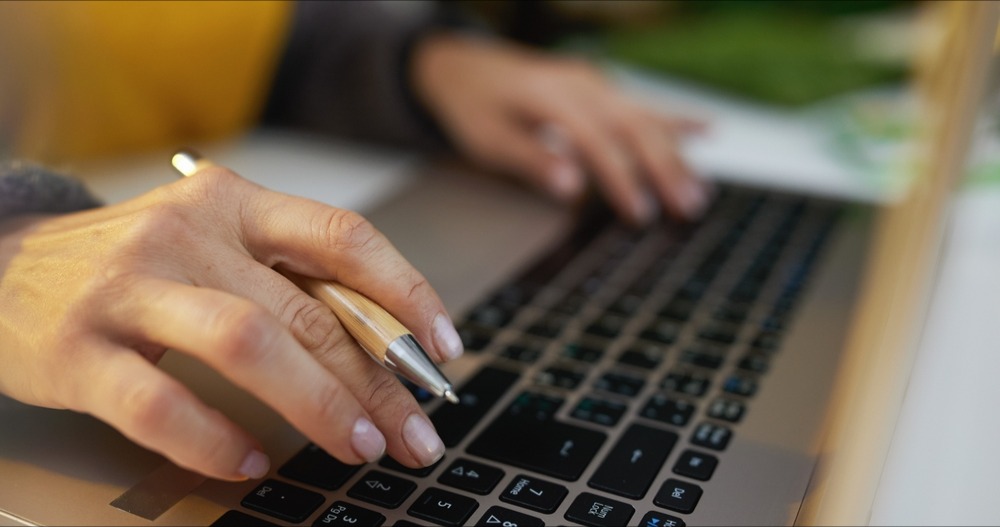 Image of female hands typing on computer keyboard