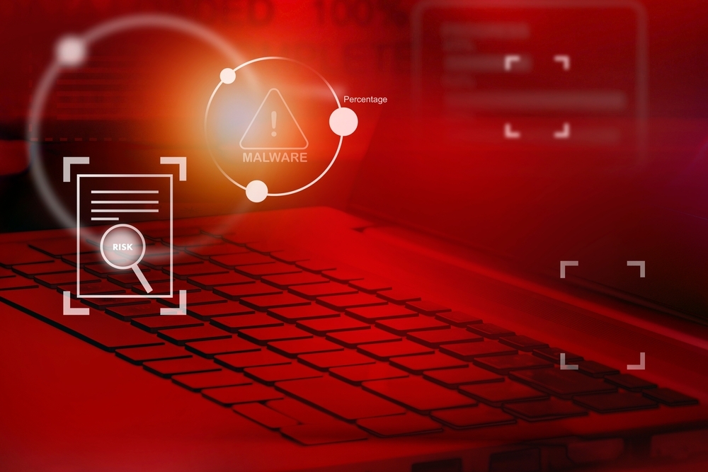 Computer keyboard in red light indicating warning